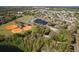 Park with a pond, baseball field, and community pool are displayed in a sunny aerial photograph at 600 Northern Way # 502, Winter Springs, FL 32708