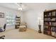 Sunlit bedroom with window views, carpeted floors and bookshelves at 600 Northern Way # 502, Winter Springs, FL 32708