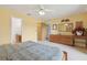 This bedroom features yellow walls, a ceiling fan, closet and bathroom access, and furnishings at 600 Northern Way # 502, Winter Springs, FL 32708