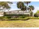 Landscaped Tuscany Place community sign with tropical palm trees and well-maintained facade at 600 Northern Way # 502, Winter Springs, FL 32708