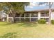 A view of the condo building featuring green lawns and mature trees at 600 Northern Way # 502, Winter Springs, FL 32708