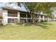 Exterior of the two-story condo building featuring private screened balconies and lush landscaping at 600 Northern Way # 502, Winter Springs, FL 32708