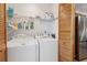 Convenient laundry room with washer, dryer, and storage shelves at 600 Northern Way # 502, Winter Springs, FL 32708