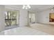 Bright living room featuring tile floors and sliding glass doors to the balcony at 600 Northern Way # 502, Winter Springs, FL 32708