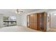 Spacious living room with glass doors leading to a balcony and custom built-in shelving at 600 Northern Way # 502, Winter Springs, FL 32708