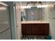 Bathroom featuring a double sink vanity with dark wood cabinets, framed mirrors, and decorative details at 6832 Sw 93Rd Ave, Ocala, FL 34481
