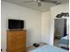 Bedroom featuring a ceiling fan, TV, dresser, and beach themed decorations at 6832 Sw 93Rd Ave, Ocala, FL 34481