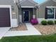Charming home entrance with a dark front door, stone landscaping, and tidy green grass at 6832 Sw 93Rd Ave, Ocala, FL 34481