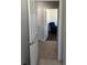 Hallway with white doors, leading to a room with a comfortable blue recliner at 6832 Sw 93Rd Ave, Ocala, FL 34481