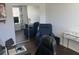 Bright home office featuring multiple monitors, blue recliner, and marble desk at 6832 Sw 93Rd Ave, Ocala, FL 34481