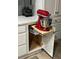 Convenient kitchen cabinet with a pull-out shelf for a mixer, maximizing space and ease of use at 6832 Sw 93Rd Ave, Ocala, FL 34481