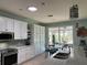 Modern kitchen with white cabinets, a kitchen island and a skylight at 6832 Sw 93Rd Ave, Ocala, FL 34481