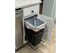 A kitchen cabinet with a clever pull-out trash can, offering convenience and space-saving functionality at 6832 Sw 93Rd Ave, Ocala, FL 34481