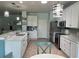 Bright kitchen features white cabinets, granite counters, stainless steel appliances, and stylish pendant lighting at 6832 Sw 93Rd Ave, Ocala, FL 34481