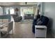 Comfortable living room featuring stylish seating, a ceiling fan, and a view of the screened-in patio at 6832 Sw 93Rd Ave, Ocala, FL 34481