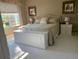 Comfortable main bedroom featuring neutral tones, patterned bedding, and a bright window with pleasant outdoor views at 6832 Sw 93Rd Ave, Ocala, FL 34481