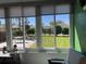 Bright sunroom featuring large windows with backyard view, neutral tones, and comfortable seating area at 6832 Sw 93Rd Ave, Ocala, FL 34481