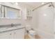 Bathroom with granite vanity, mirrored cabinet, toilet, and a shower-tub combo with white tile surround at 6936 Hochad Dr, Orlando, FL 32819