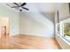 Bedroom showcasing hardwood floors, bright windows, ceiling fan, and private entry to the staircase at 6936 Hochad Dr, Orlando, FL 32819