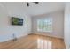 Bedroom featuring hardwood floors, a ceiling fan, and a wall-mounted television for entertainment at 6936 Hochad Dr, Orlando, FL 32819