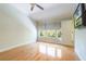 Bedroom boasting hardwood floors, three large windows, ceiling fan, and bright walls at 6936 Hochad Dr, Orlando, FL 32819