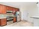 Compact kitchen featuring stainless steel appliances, ample storage, and a practical layout at 6936 Hochad Dr, Orlando, FL 32819
