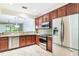 Functional kitchen boasts stainless steel appliances, granite counters, and an open layout to the living room at 6936 Hochad Dr, Orlando, FL 32819