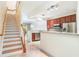Open kitchen featuring granite countertops, stainless steel appliances, and easy access to the staircase at 6936 Hochad Dr, Orlando, FL 32819