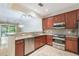 Well-equipped kitchen with stainless steel appliances, granite countertops, and a seamless connection to the living space at 6936 Hochad Dr, Orlando, FL 32819