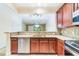 Charming kitchen offering granite countertops, stainless steel appliances, and a view of the living area at 6936 Hochad Dr, Orlando, FL 32819