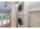 Laundry closet with stacked washer and dryer adjacent to bedroom at 6936 Hochad Dr, Orlando, FL 32819