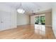 Spacious living room featuring hardwood floors, neutral walls, and a sliding door to screened-in porch at 6936 Hochad Dr, Orlando, FL 32819