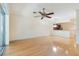 Bright, open living room featuring hardwood floors and a ceiling fan with seamless transition to the kitchen area at 6936 Hochad Dr, Orlando, FL 32819