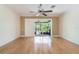 Expansive living room featuring hardwood floors and sliding door access to the screened porch at 6936 Hochad Dr, Orlando, FL 32819