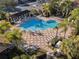 Aerial view of community pool surrounded by palm trees, lounge chairs, tables, and a pergola at 6936 Hochad Dr, Orlando, FL 32819