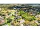 A high aerial view showing the property in relation to the surrounding neighborhood and lush greenery at 701 Palenci Ct, Winter Springs, FL 32708