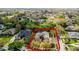 An aerial view of a green home showing the roof, driveway, yard and surrounding trees at 701 Palenci Ct, Winter Springs, FL 32708