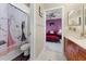 Bathroom offers a shower with a decorative curtain, vanity with cherry cabinets and access to the bedroom at 701 Palenci Ct, Winter Springs, FL 32708