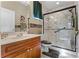 This updated bathroom features a granite vanity, shower with glass enclosure, and modern fixtures at 701 Palenci Ct, Winter Springs, FL 32708