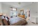 Comfortable bedroom featuring carpet and a view to the ensuite bathroom and the outside at 701 Palenci Ct, Winter Springs, FL 32708