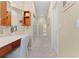 Hallway view showcasing vanity area, closet doors and design flow into adjoining rooms at 701 Palenci Ct, Winter Springs, FL 32708