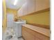 The laundry room features a washer, dryer, ample counter space, and cabinetry for storage and organization at 701 Palenci Ct, Winter Springs, FL 32708