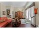 Elegant living room with hardwood floors, a decorative cabinet, and large windows offering ample natural light at 701 Palenci Ct, Winter Springs, FL 32708