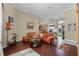 Open-concept living room with hardwood floors, neutral paint, and a view into the dining room at 701 Palenci Ct, Winter Springs, FL 32708