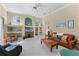 Spacious living room featuring vaulted ceilings, built-in shelving and cozy seating at 701 Palenci Ct, Winter Springs, FL 32708