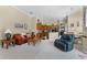 Open-concept living room with kitchen view, neutral colors, and comfortable seating at 701 Palenci Ct, Winter Springs, FL 32708