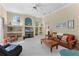 Inviting living room with built-in shelving, neutral carpet, and comfortable seating at 701 Palenci Ct, Winter Springs, FL 32708