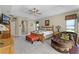 Spacious main bedroom with tray ceilings, a ceiling fan, a sitting area, and plush carpeting at 701 Palenci Ct, Winter Springs, FL 32708