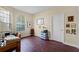 Well-lit home office with hardwood floors, a large window, and ample desk space at 701 Palenci Ct, Winter Springs, FL 32708