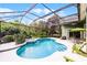 Screened-in pool and spa with a waterfall feature, surrounded by a patio with seating at 701 Palenci Ct, Winter Springs, FL 32708